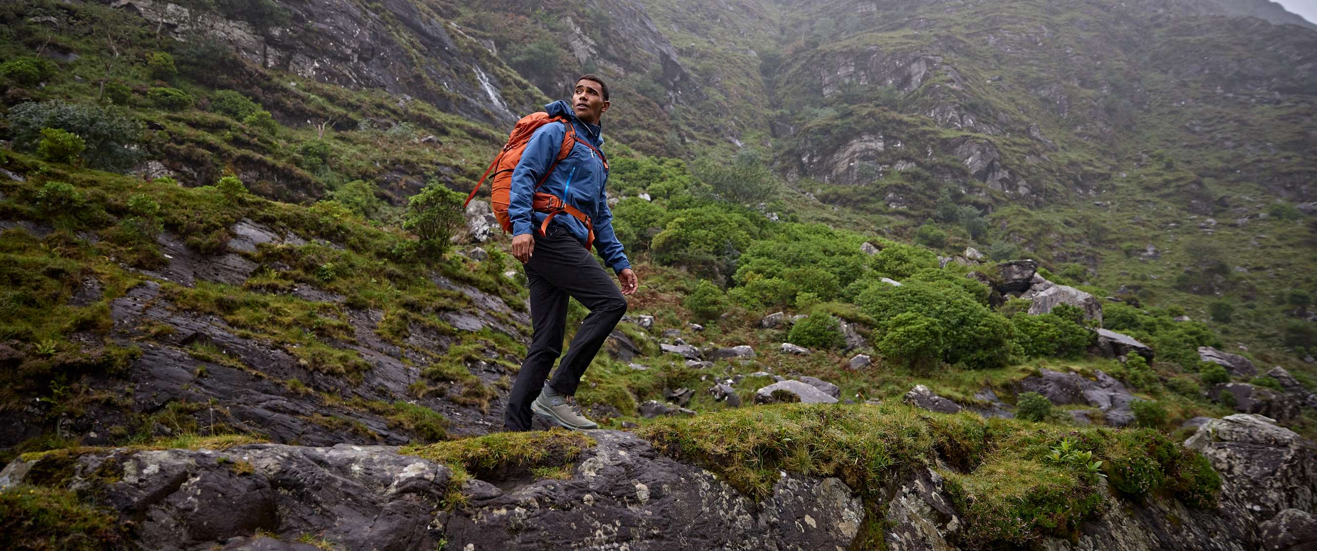 Wandelaar in outdoor kleding in een bergachtig landschap