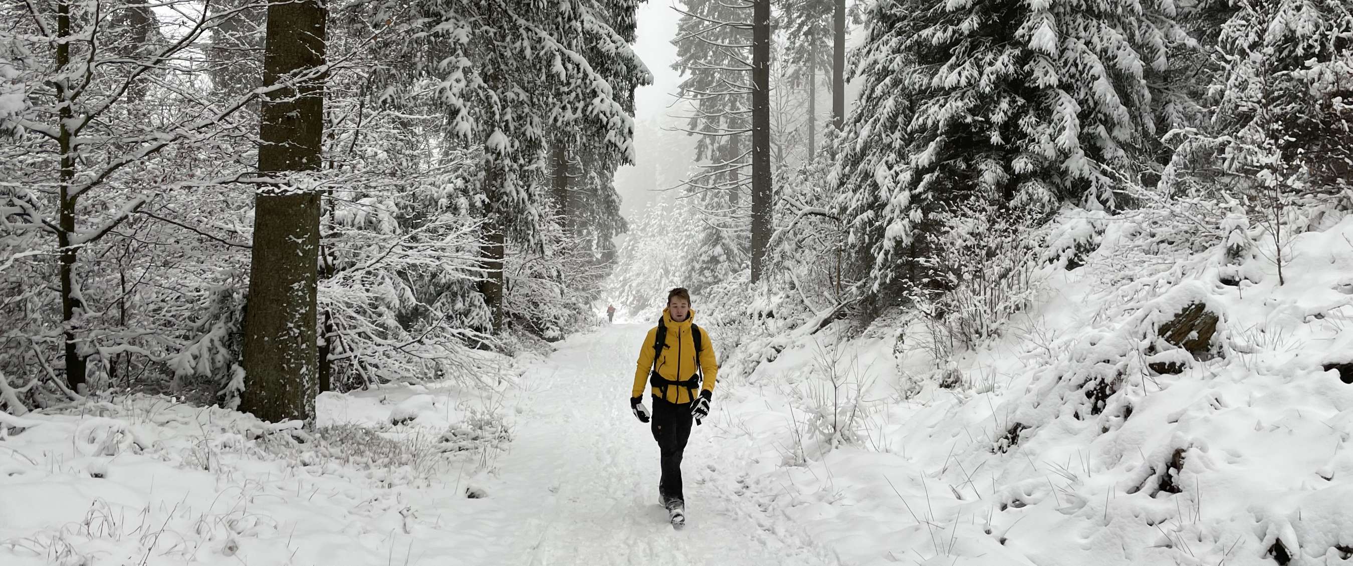 Marcheur en vêtements d’hiver sur un chemin couvert de neige